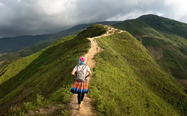 girl is walking over the mountain of kerala